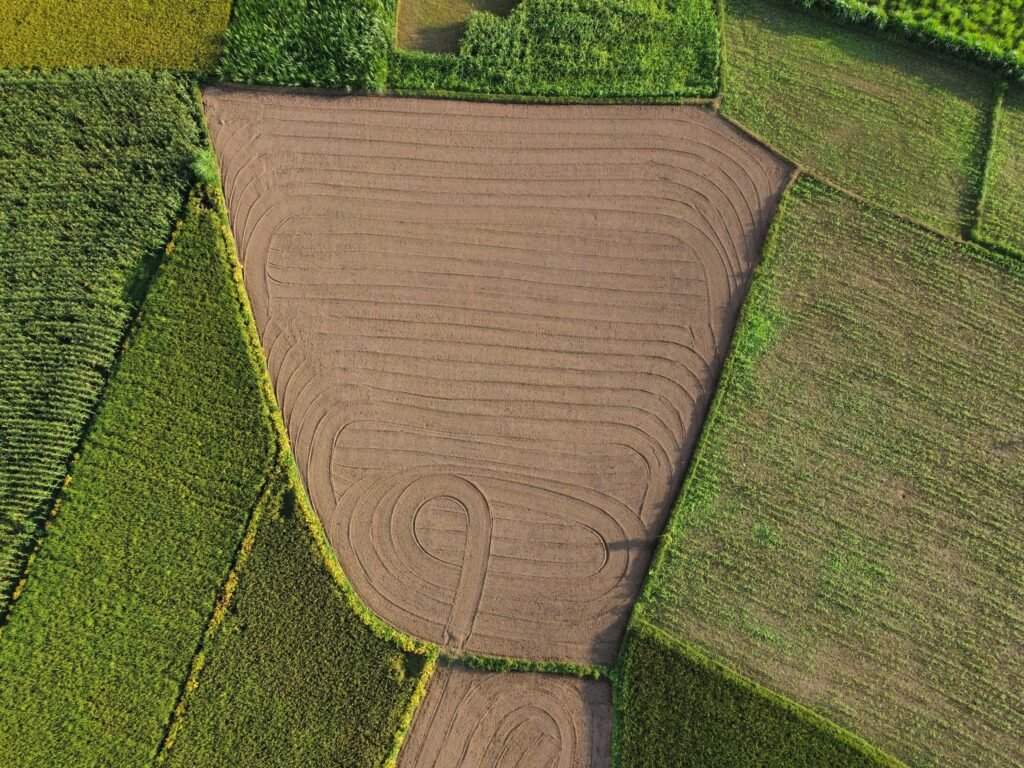 Stunning aerial photo of vibrant patchwork farmland ready for cultivation.